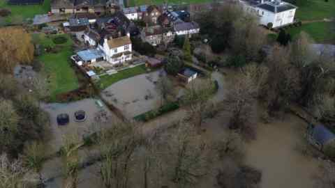 Flood waters from the River Ouse approach properties in Barcombe Mills, East Sussex.