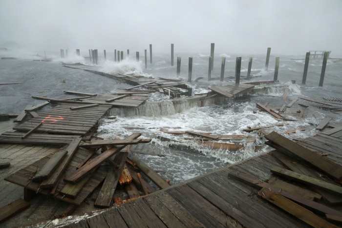 Strong winds and waves destroy parts of a boardwalk in Atlantic Beach, North Carolina, in 2018