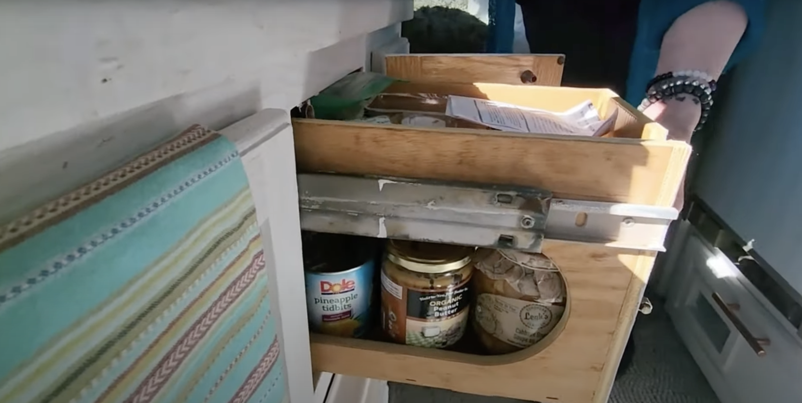 There is a handy little pantry with a junk drawer on top