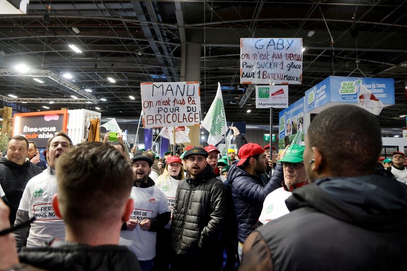 Angry French farmers storm into agriculture fair in Paris