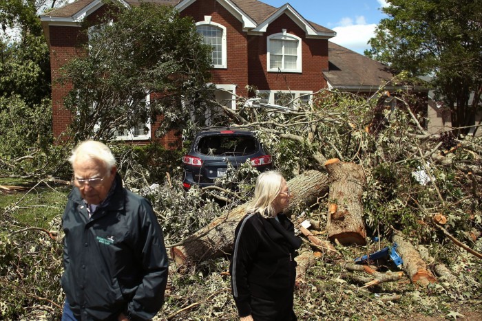 Residents in Virginia Beach examine the damage after a tornado last year