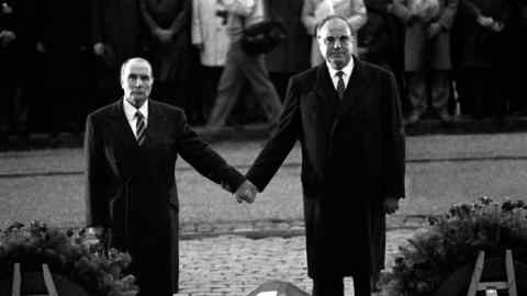 François Mitterrand and Helmut Kohl link hands in a show of solidarity in 1984