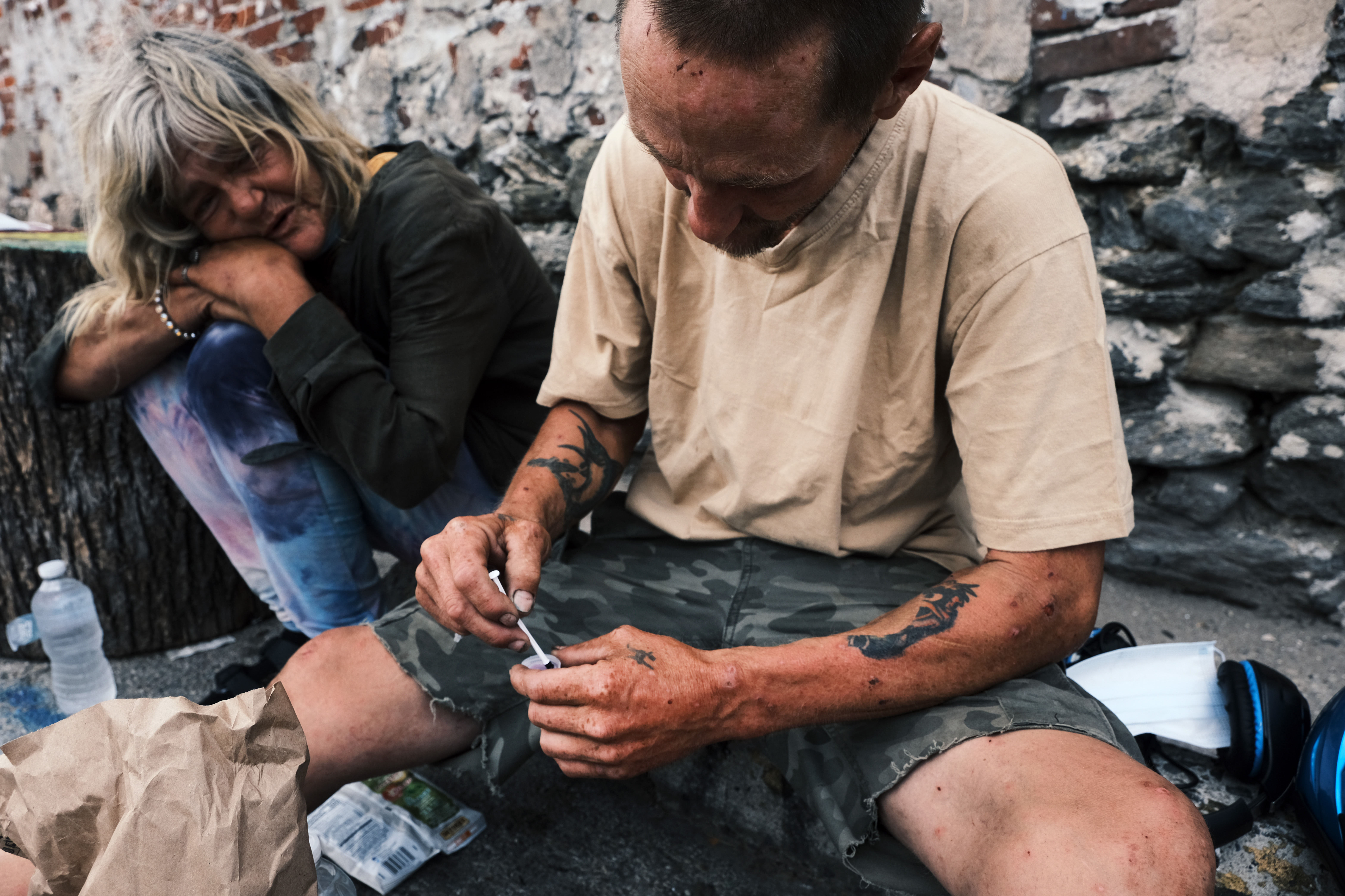 Two heroin users shoot up on the street in Kensington, Philadelphia
