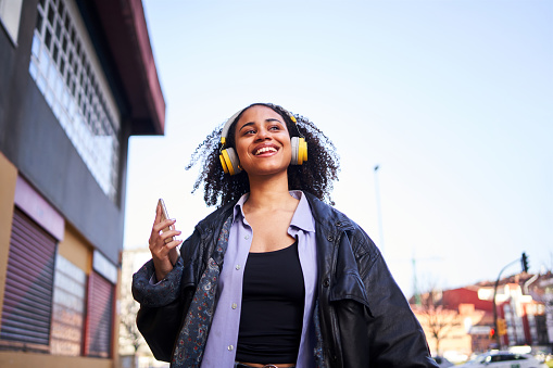 A woman listening to music on headphones
