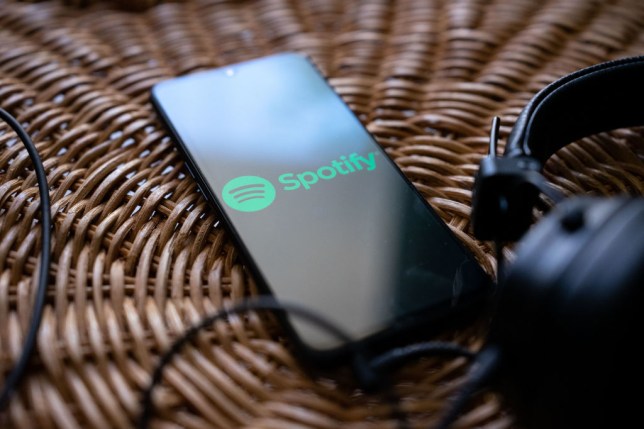 The Spotify logo on a mobile phone
