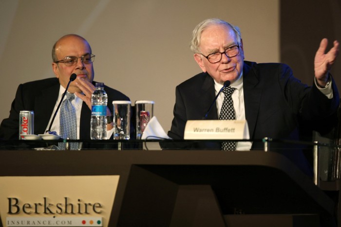 Ajit Jain, left, looks on as Warren Buffett speaks at a meeting with insurance customers in New Delhi in 2011